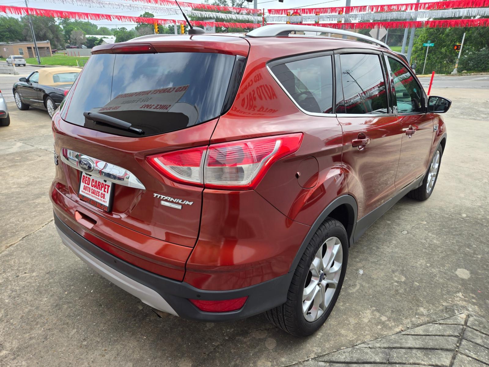 2014 Orange Ford Escape Titanium 4WD (1FMCU9JX7EU) with an 1.6L L4 DOHC 16V engine, 6-Speed Automatic transmission, located at 503 West Court, Seguin, TX, 78155, (830) 379-3373, 29.568621, -97.969803 - 2014 Ford Escape Titanium 4WD with a 1.6L L4 DOHC 16V, Automatic, Tilt, Cruise, AM/FM/CD Touchscreen Stereo, Power Windows, Locks, Seat and Side Mirrors, Leather Seating, Bluetooth, Dual Climate Control, Rear A/C, Rear Camera, Bumper Sensors, Alloy Wheels, Rear Defroster, Rear Wiper and more!! - Photo #2